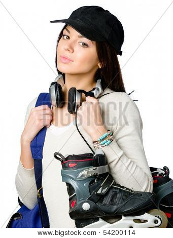Half-length portrait of teenager handing roller skates and wearing peaked cap, blue rucksack and earphones, isolated on white