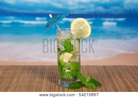 Green cocktail of alcohol with an umbrella