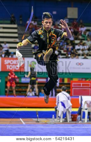 KUALA LUMPUR - NOV 03: USA's Jeffrey Lui performs with a staff in the Men's 'Nangun' Event at the 12th World Wushu Championship on November 03, 2013 in Kuala Lumpur, Malaysia.