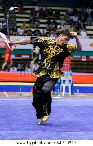 KUALA LUMPUR - NOV 03: Macau's Wu Nok In performs with a sword in the Men's 'Daoshu' Event at the 12th World Wushu Championship on November 03, 2013 in Kuala Lumpur, Malaysia.