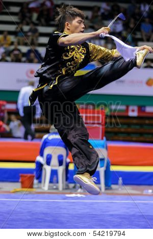 KUALA LUMPUR - NOV 03: Macau's Wu Nok In performs with a sword in the Men's 'Daoshu' Event at the 12th World Wushu Championship on November 03, 2013 in Kuala Lumpur, Malaysia.