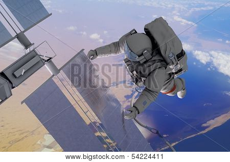 Astronaut working in space above the planet.