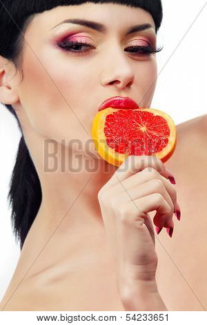 Female face with pummelo slice over white background