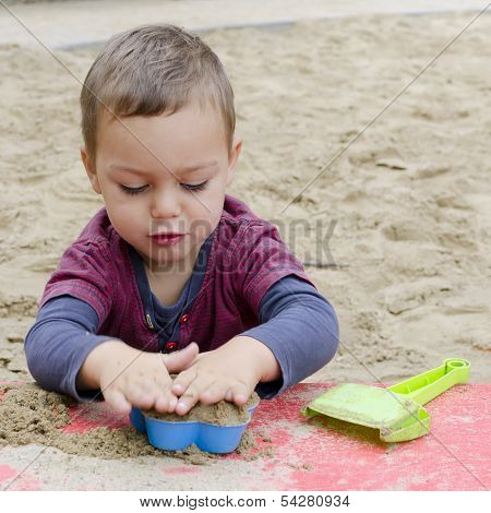 Child Playing In Sandpit
