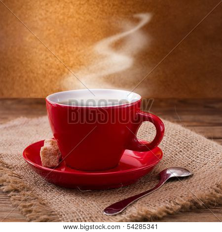 Coffee cup and saucer on  wooden table.