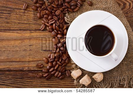 Coffee cup and saucer on  wooden table.
