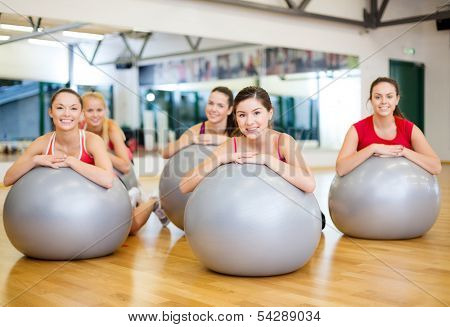 fitness, sport, training, gym and lifestyle concept - group of smiling people working out in pilates class