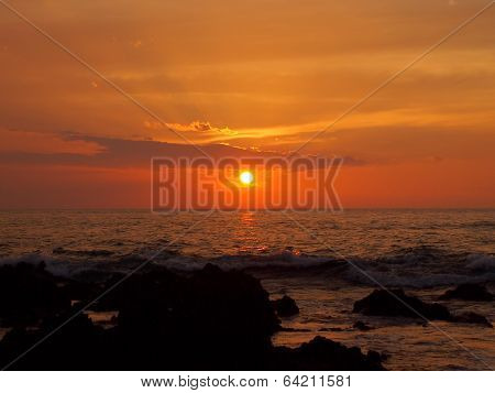 Sunset Over Ocean With Lava Rocks Of Holoholokai Beach In The Foreground