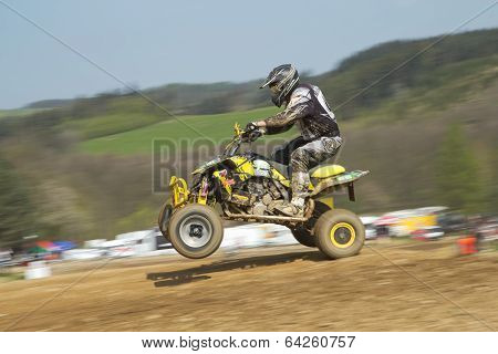 Dynamic Shot Of Quad Racer Jumping