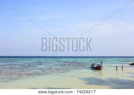 LIPE ISLAND, SATUN, THAILAND - SEP29, 2014: Fisherman Sailed Longtail Boat On The Beach