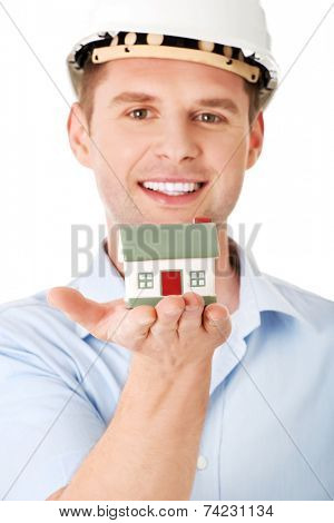 A forewoman holding a model house in hand