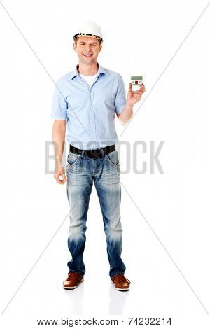 A forewoman holding a model house in hand