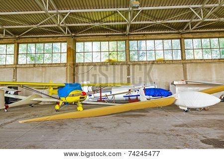 Lightweight Gliders Stationed Inside Of A Big Hangar