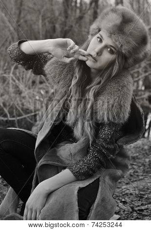 portrait photo of fashion beautiful model girl beauty girl sitting on the ground wearing fur clothes