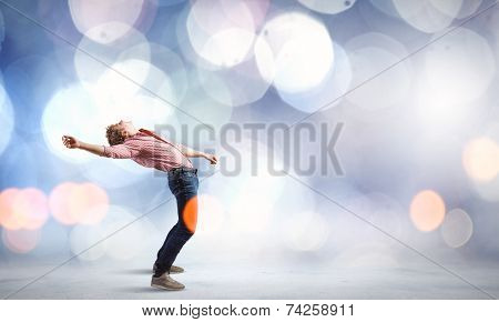 Young guy in casual evading from light rays