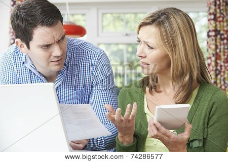 Worried Couple Discussing Domestic Finances At Home