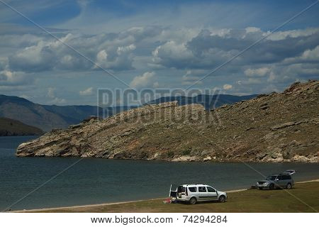 Two Cars On The Shore Of The Lake Baikal