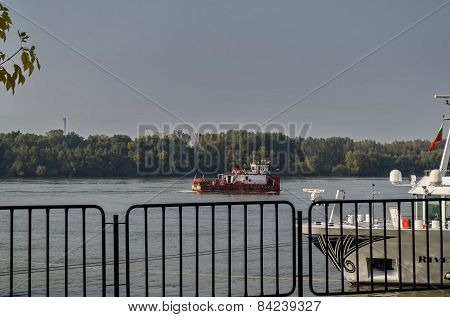 Tugboat pass along the Ruse port at Danube river