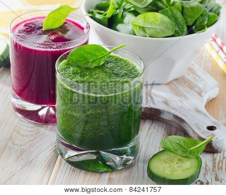 Glasses Of Freshly Squeezed Vegetable Juices On A Wooden Table