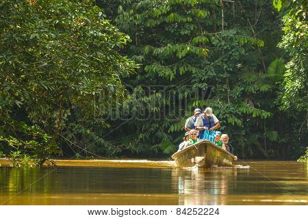 Cuyabeno, Ecuador - 20 March 2015: Happy European Biologists In The Canoe Crossing Cuyabeno River, South America In Cuyabeno On March 20, 2015