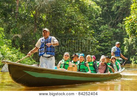 Cuyabeno, Ecuador - 20 March 2015: Middle Age European Biologists In The Canoe Crossing Cuyabeno River, South America In Cuyabeno On March 20, 2015