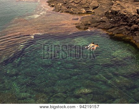 People Diving In A Natural Basin In The Rocks Coastline Of Lanzarote