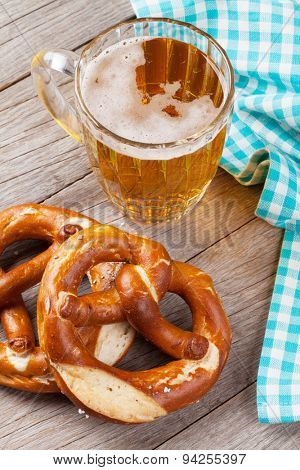 Beer mug and pretzel on wooden table