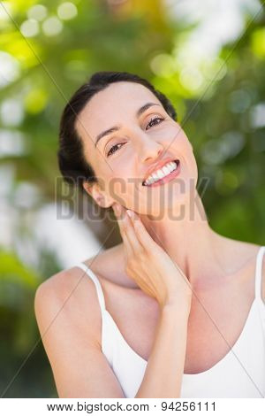 Portrait of a woman in a meditation position against a white background
