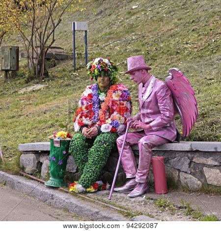 Two Unidentified Busking Mimes In Costumes Relax At Park In Kiev, Ukraine
