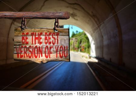 Be the best version of you motivational phrase sign on old wood with blurred background