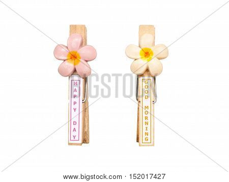 Wood clothespins with flower and wording happy day and good morning isolated on white background