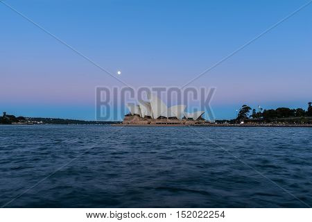 Sydney opera house  view with full moon at sunset in Sydney,Australia.Oct 17,2016 Sydney Opera House is  famous arts center. Over 10 millions tourists visit Sydney a year.