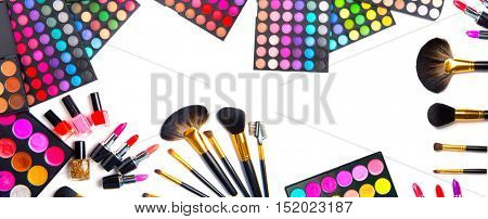 Makeup. Make-up Set Palette with colorful eyeshadows. Various cosmetics Brushes, lipgloss, lipstick, rouge, eyeshadow tints, foundation isolated on a white background. Make up artist tools Wide banner