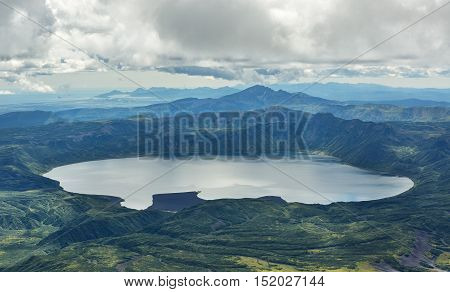 Crater Karymsky Lake. Kronotsky Nature Reserve on Kamchatka Peninsula. View from helicopter.