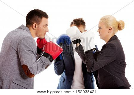 Three business people wearing boxing gloves start competition fight 