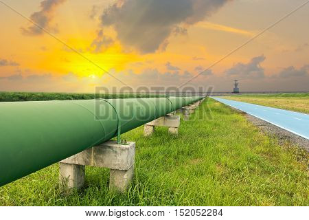 Straight line of potable water pipe on sunrise.