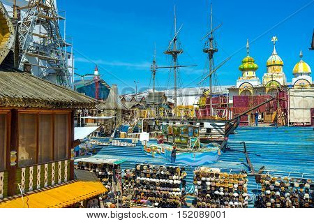 MOSCOW RUSSIA - MAY 10 2015: The wooden ship sails in painted timbered sea in the middle of the souvenir Vernissage market in Izmailovo on May 10 in Moscow.