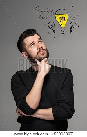 Man t is looking reminiscing. Over gray background. concept of idea