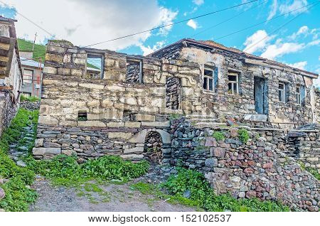 Some old stone houses of Stepantsminda are ruined and abandoned Kazbegi Georgia.