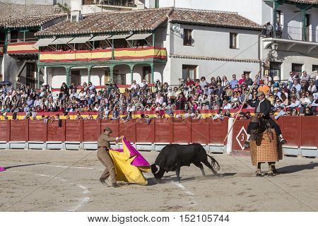 Chinchon Spain - October 15 2016: Traditional bullfighting stamp in the main square of chinchon during the festival charity Chinchon Madrid province Spain