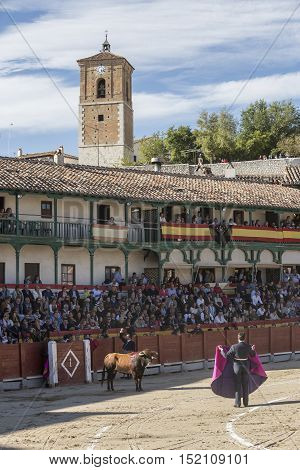 Chinchon Spain - October 15 2016: Traditional bullfighting stamp in the main square of chinchon during the festival charity Chinchon Madrid province Spain