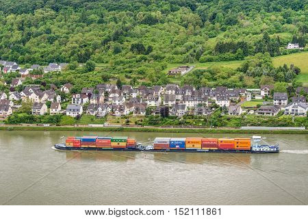 Spay Germany - May 23 2016: Container ship on the Rhine River Rhine Valley UNESCO World Heritage Site Germany. Spay is a municipality in the district of Mayen-Koblenz in Rhineland-Palatinate western Germany.