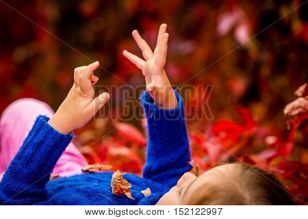 Little Girl On A Beautiful Background Of Autumn Wild Grapes