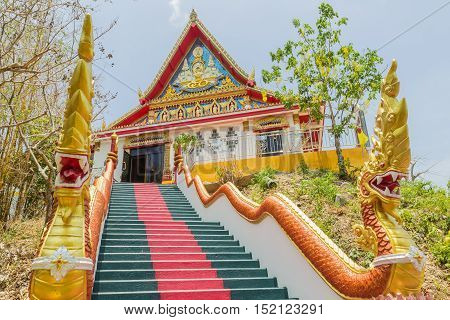 Phuket Thailand - April 25 2016 : The main stair leading to the replica of Phra That In-Kwaen (Hanging Golden Rock) at Sirey temple Phuket Thailand.