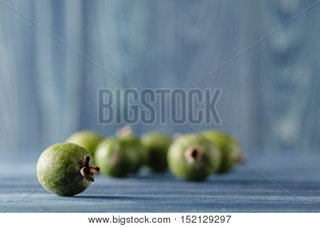 Feijoa, Pineapple Guava On A Dark Wood Background. Selective Focus