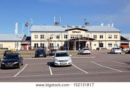 Karlstad, Sweden - May 26 2016: Parking with parked cars in front of Karlstad airport terminal building.