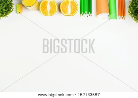 White tabletop with orange halves supplies decorative plants and copy space. Mock up