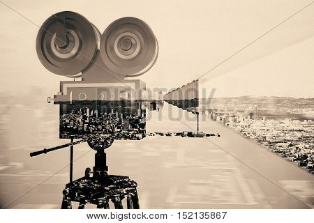 Retro movie camera on abstract city background. Double exposure. Cinema concept. Vintage filter