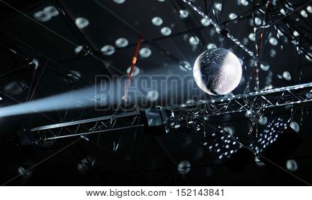 Lights and spots of shinning ceiling glitterball at disco hall