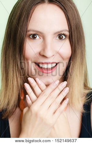 Lovely shy woman lauging. Smiling girl embarrassed covers her face with palms